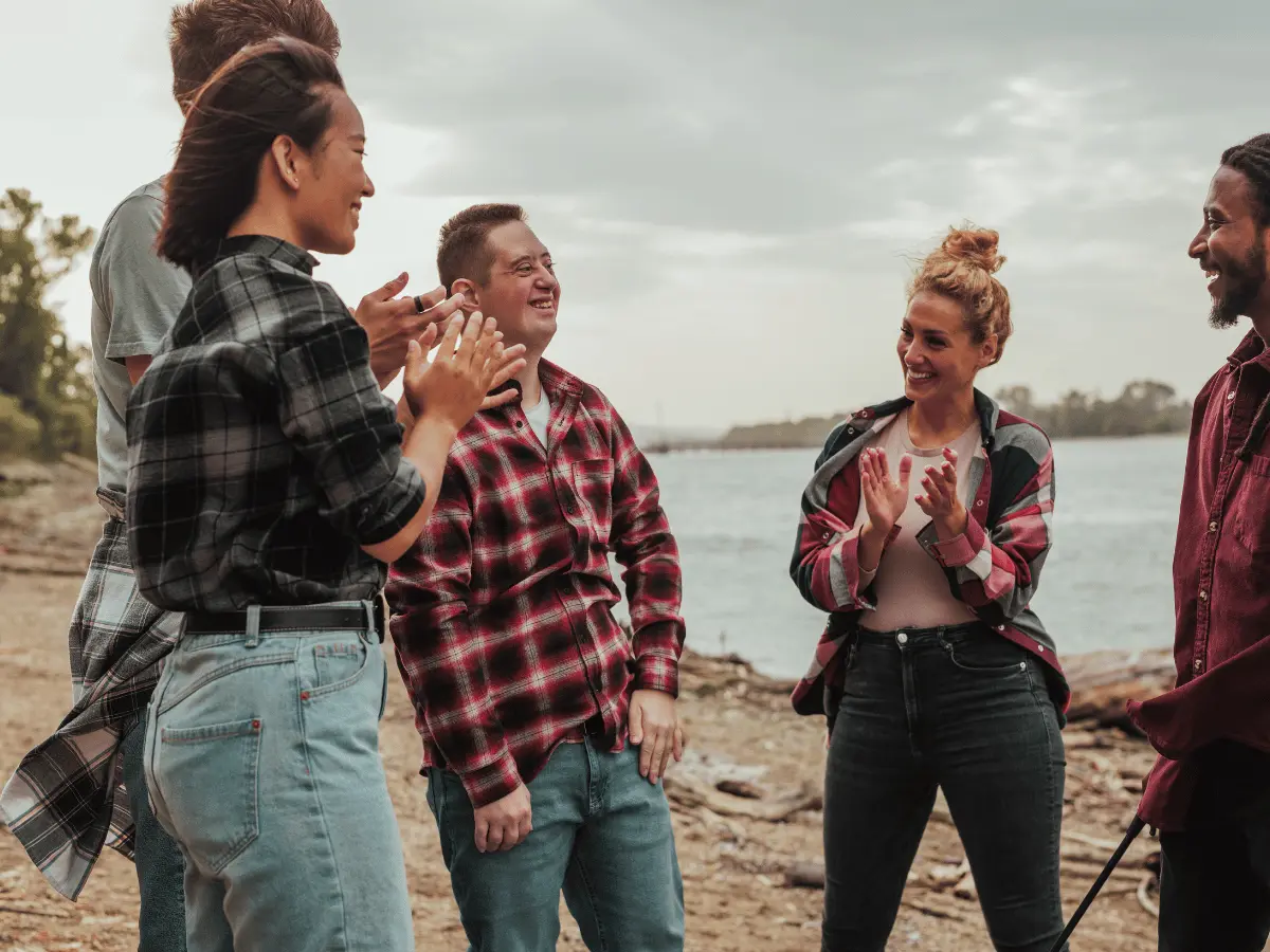Man with down syndrome laughing with group of friends